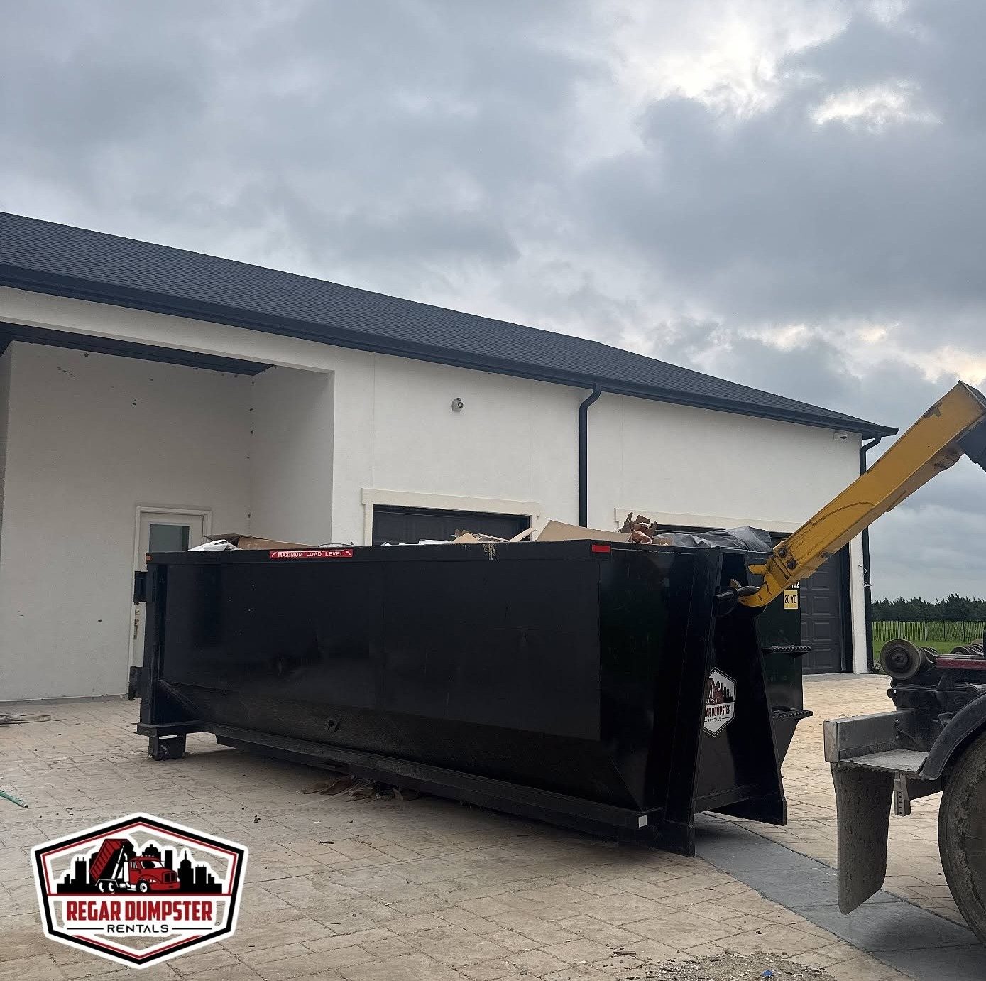 Regar construction dumpster on a job site in Greenville, TX