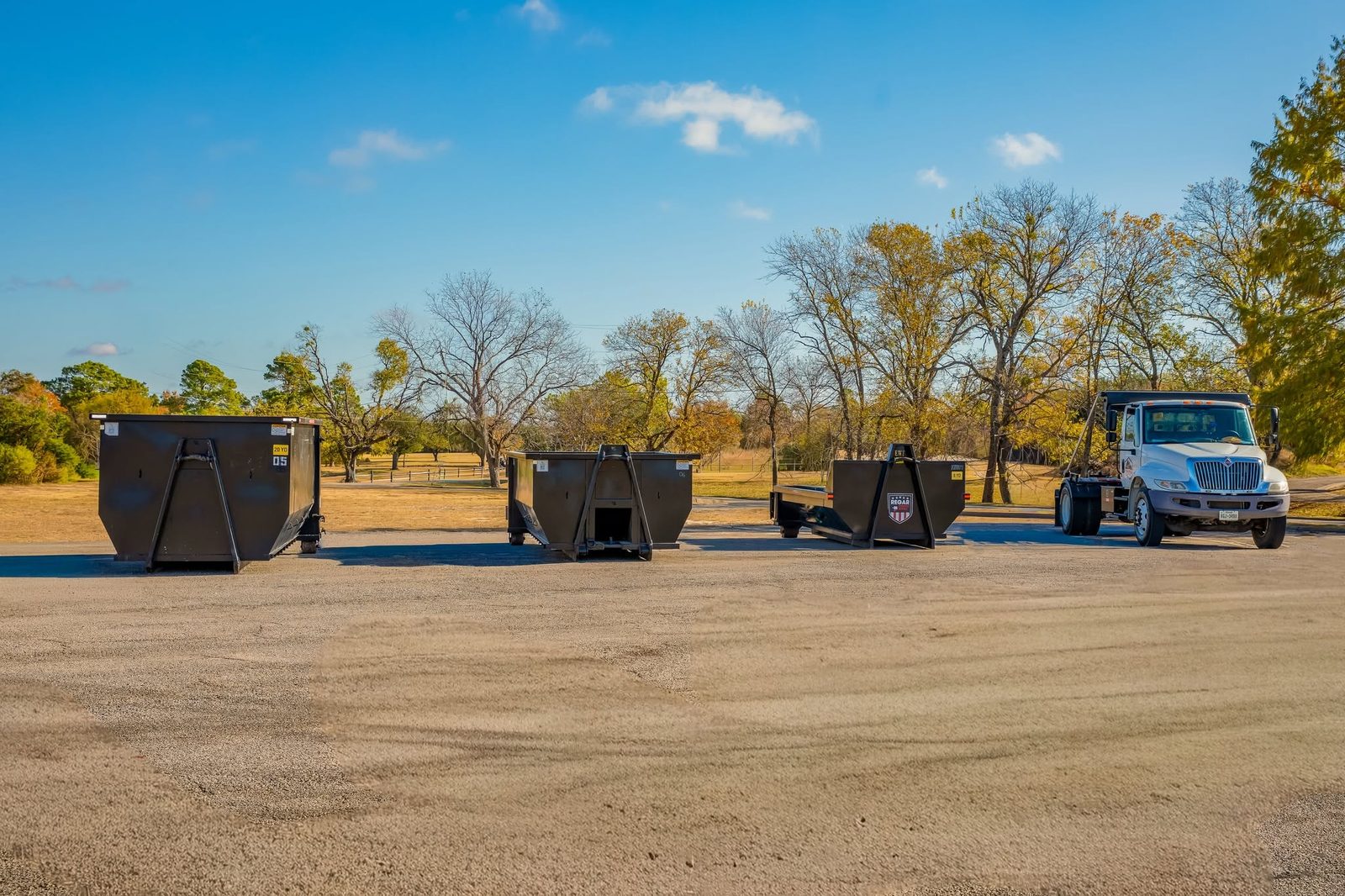 Regar Dumpster Rentals roll-off dumpsters and truck in Greenville, TX