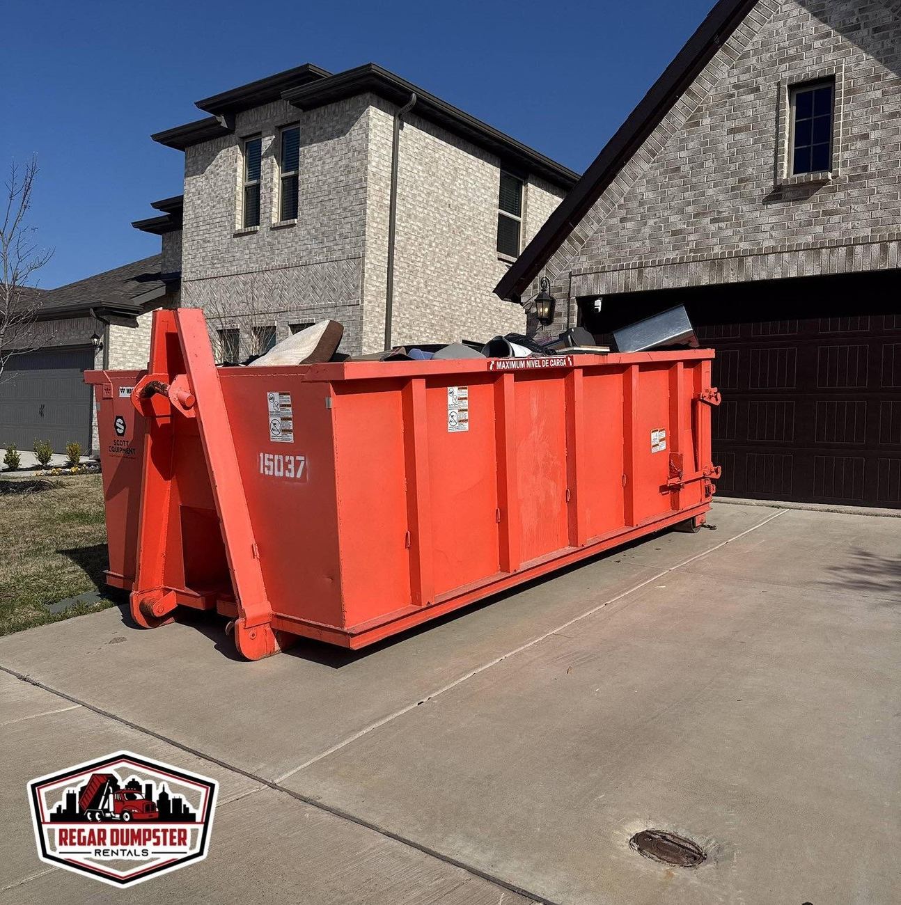 Regar dumpster on a residential driveway in Hunt County
